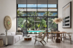 Double-height living area of a two-bedroom residence at AURA Playacar, Playa del Carmen.