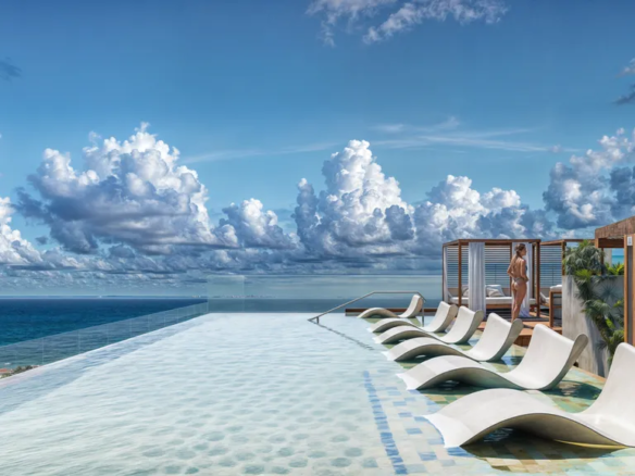Ocean-view rooftop infinity pool at Macondo Corazón condos in Playa del Carmen.