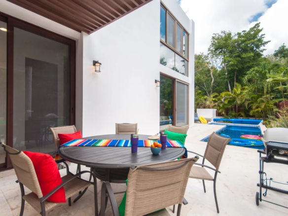Heated pool and outdoor dining at Casa Bahamas Tulum