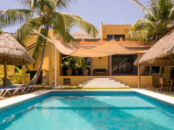 Garden pool and palapa at the Caleta Tankah property