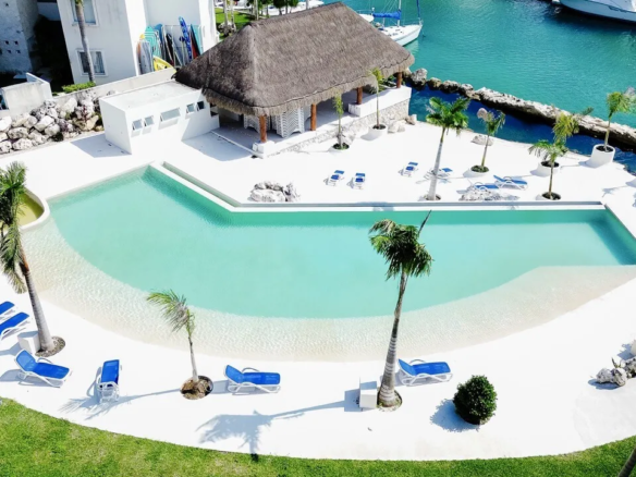 Pool and palapa on the canal at Bloom Puerto Aventuras